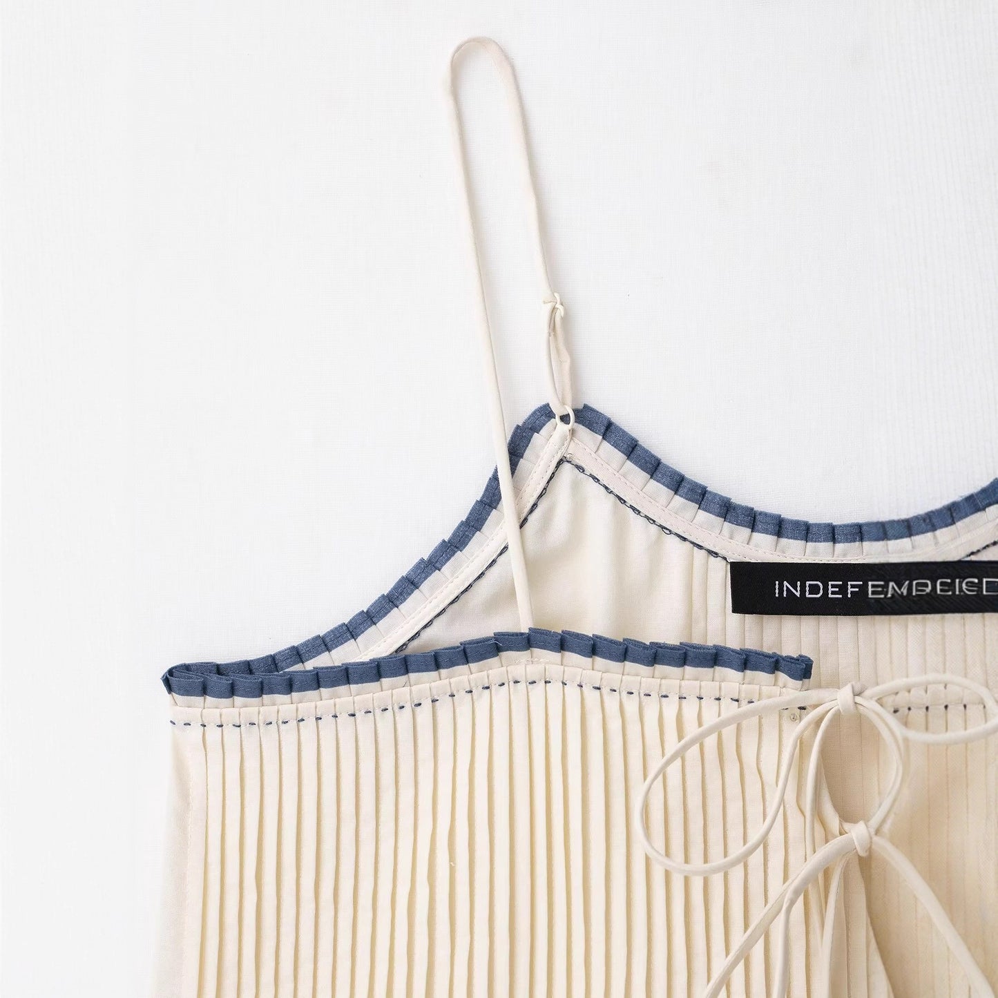 Low neck contrasting color embellished camisole top